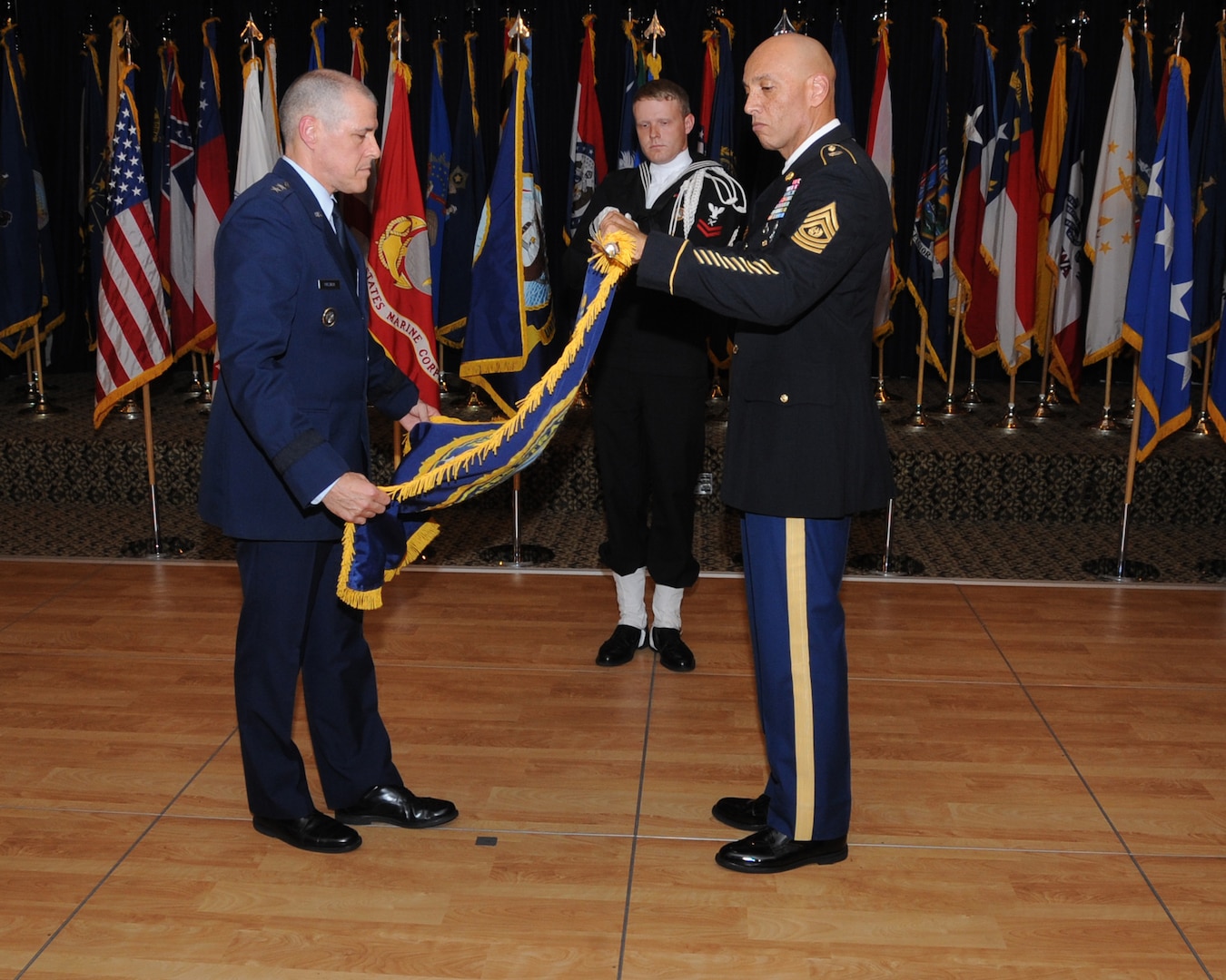 U.S. Air Force Maj. Gen. Thomas A. Bussiere, outgoing commander of Joint Functional Component Command for Global Strike (JFCC GS), and U.S. Army Command Sgt. Maj. Nathaniel Jett, JFCC GS senior enlisted leader, furl and case the JFCC GS flag, marking the command’s inactivation at the Patriot Club on Offutt Air Force Base, Neb., Oct. 2, 2017. U.S. Strategic Command inactivated JFCC GS as part of the command’s restructure of its components to build a coherent and streamlined warfighting structure. The restructure will enhance integration throughout the deterrence enterprise and match the organizational structure of other warfighting commands.