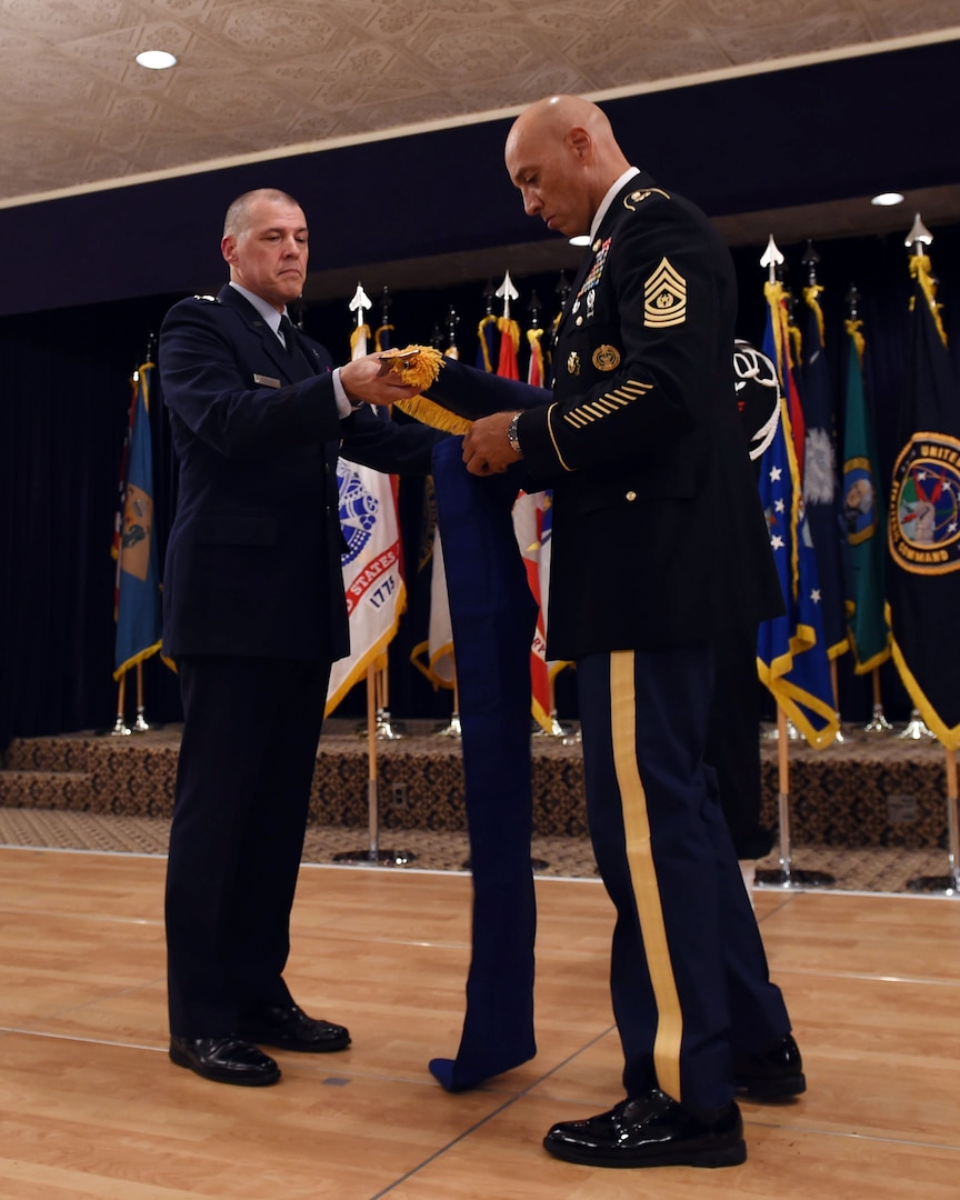 U.S. Air Force Maj. Gen. Thomas A Bussiere, outgoing commander of Joint Functional Component Command for Global Strike (JFCC GS), and U.S. Army Command Sgt. Maj. Nathaniel Jett, JFCC GS senior enlisted leader, furl and case the JFCC GS flag, marking the command’s inactivation at the Patriot Club on Offutt Air Force Base, Neb., Oct. 2, 2017. U.S. Strategic Command inactivated JFCC GS as part of the command’s restructure of its components to build a coherent and streamlined warfighting structure. The restructure will enhance integration throughout the deterrence enterprise and more closely match the organizational structure of other warfighting commands.