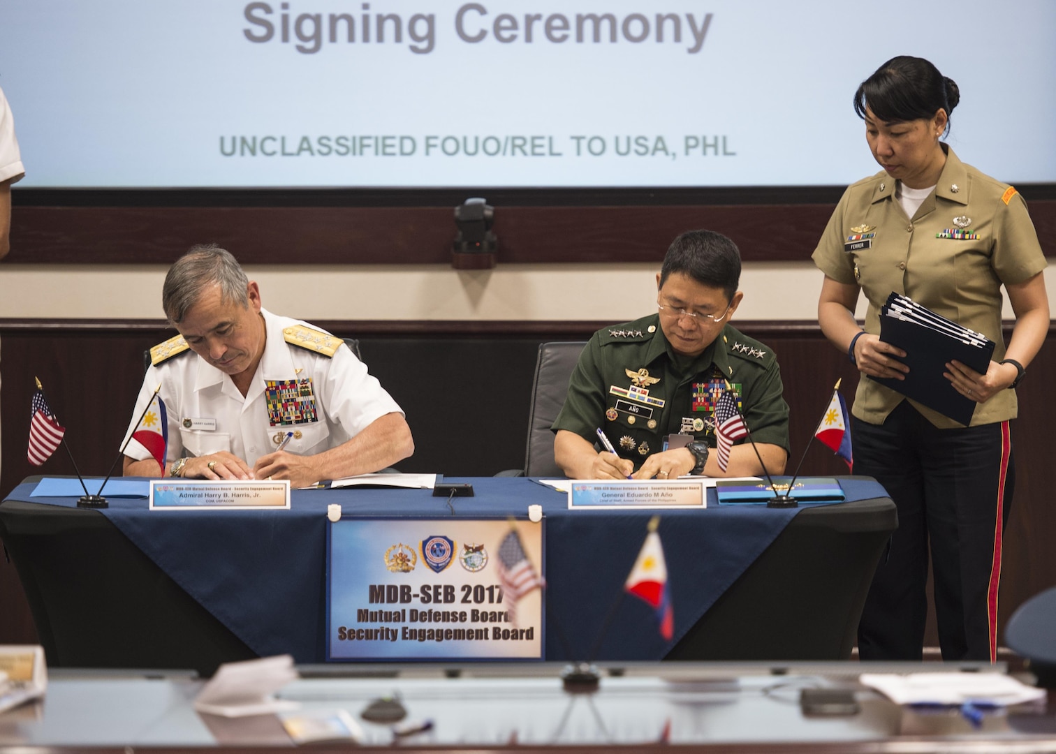 CAMP H.M. SMITH, Hawaii (Sept. 28, 2018) — Adm. Harry Harris, Commander of U.S. Pacific Command (PACOM), and Gen. Eduardo Año, Chief of Staff for the Armed Forces of the Philippines, sign paperwork for the Mutual Defense Board (MDB) and Security Engagement Board (SEB). During Año’s two-day visit to PACOM, he and Harris discussed changes to the MDB and SEB. The MDB provides direct liaison and consultation on military matters of mutual concern to develop and improve both countries’ common defense. The SEB provides the framework and mechanism for continuing liaison and consultation on non-traditional threats to security such as terrorism, transnational crimes, maritime security, and natural and man-made disasters. (U.S. Navy photo by Mass Communication Specialist 2nd Class James Mullen/Released)