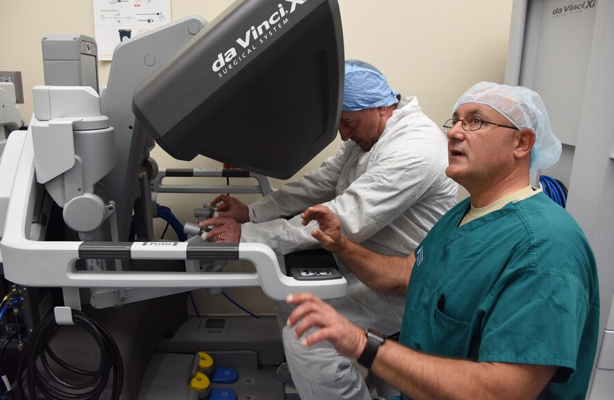 Maj. Scott Thallemer, perioperative nurse and robotics coordinator with the Institute for Defense Robotic Surgical Education (InDoRSE), trains Maj. Gen. Timothy Leahy, 2nd Air Force commander, on the da Vinci X surgical system used in robotics surgery at the Keesler Medical Center, Sept. 26, 2017, on Keesler Air Force Base, Miss. InDoRSE is working with the Air Force Research Lab to understand trust between surgical teams and the robot in order to improve on the training program. Trust is a key factor in determining proper use of such innovative technology as surgical robots. (U.S. Air Force photo by Kemberly Groue)