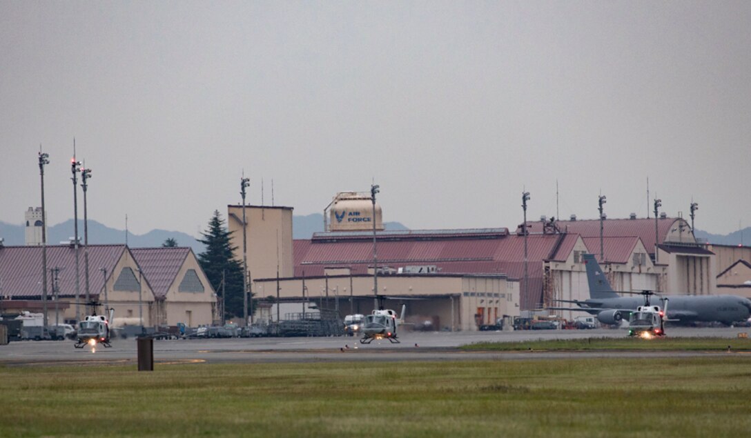 Three UH-1N Iroquois helicopters assigned to the 459th Airlift Squadron take off for a formation flight