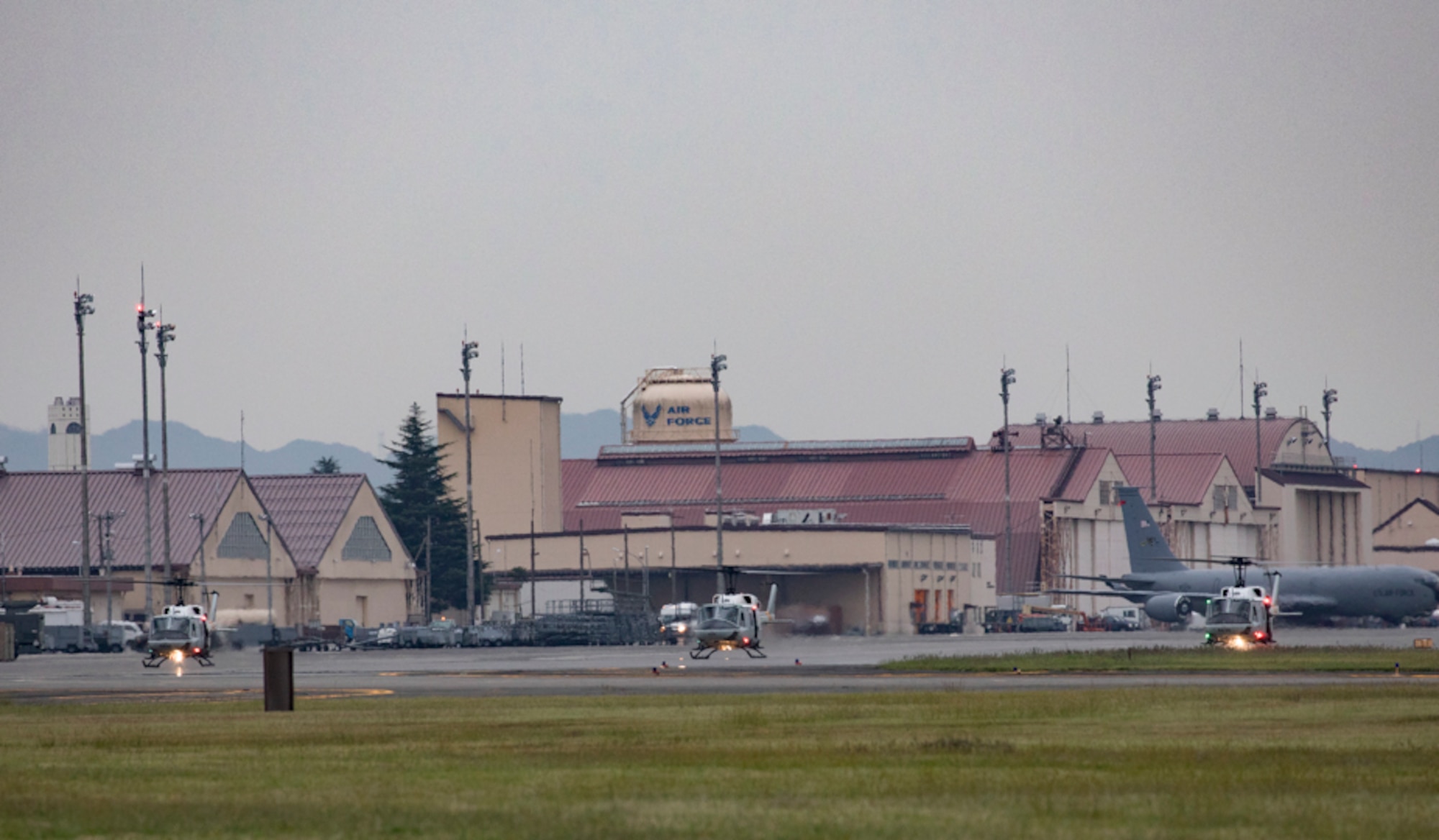 Three UH-1N Iroquois helicopters assigned to the 459th Airlift Squadron take off for a formation flight
