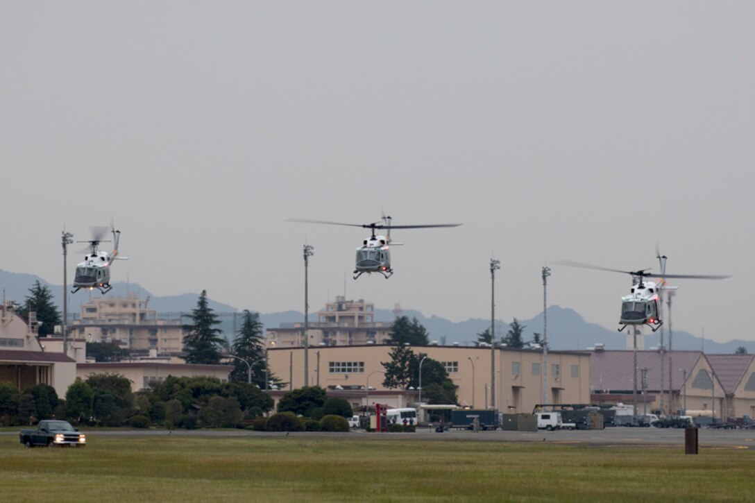Three UH-1N Iroquois helicopters assigned to the 459th Airlift Squadron take off for a formation flight