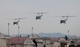 Three UH-1N Iroquois helicopters assigned to the 459th Airlift Squadron take off for a formation flight