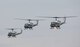 Three UH-1N Iroquois helicopters assigned to the 459th Airlift Squadron take off for a formation flight