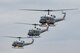 Three UH-1N Iroquois helicopters assigned to the 459th Airlift Squadron take off for a formation flight