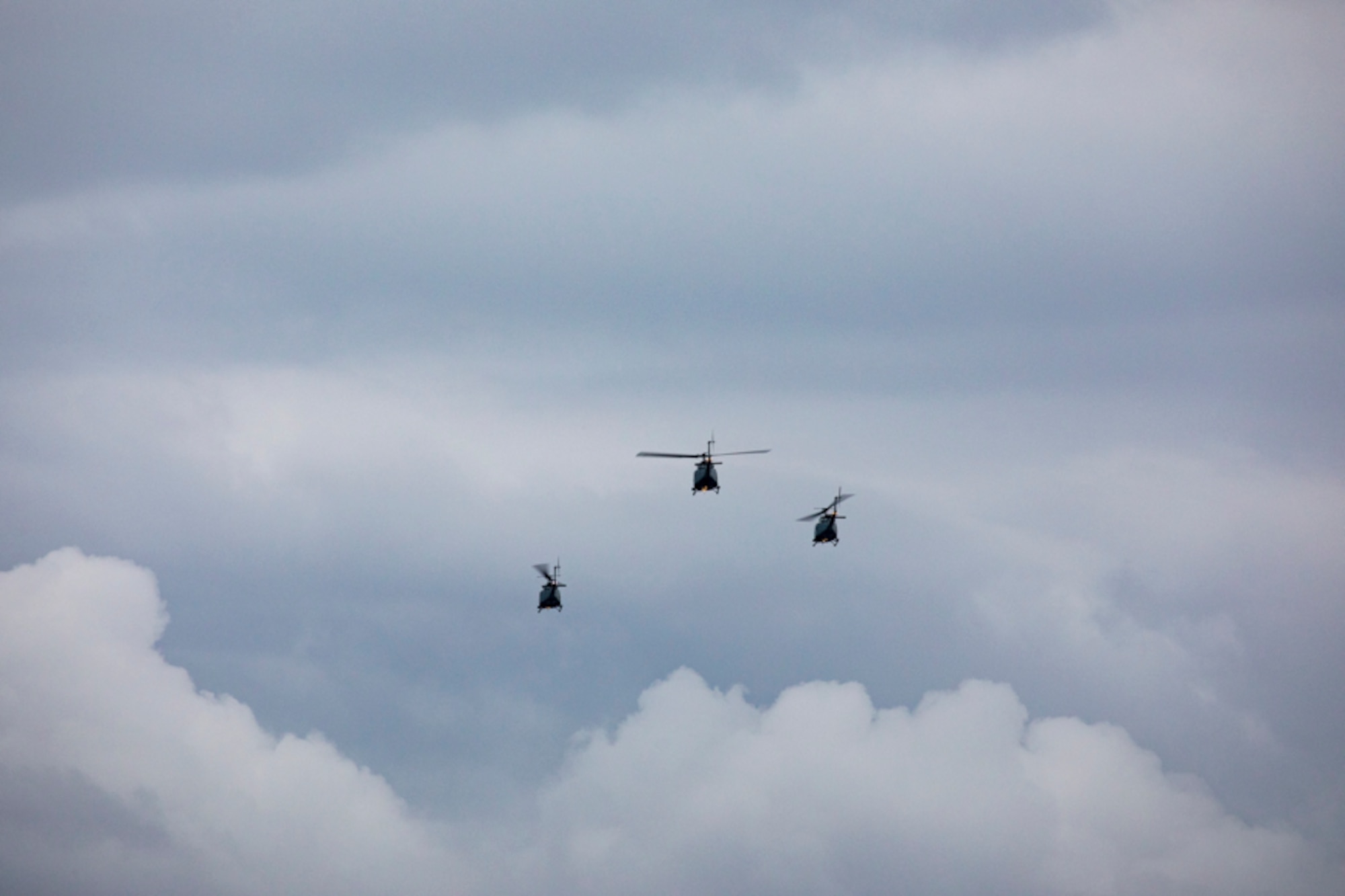 Three UH-1N Iroquois helicopters assigned to the 459th Airlift Squadron take off for a formation flight