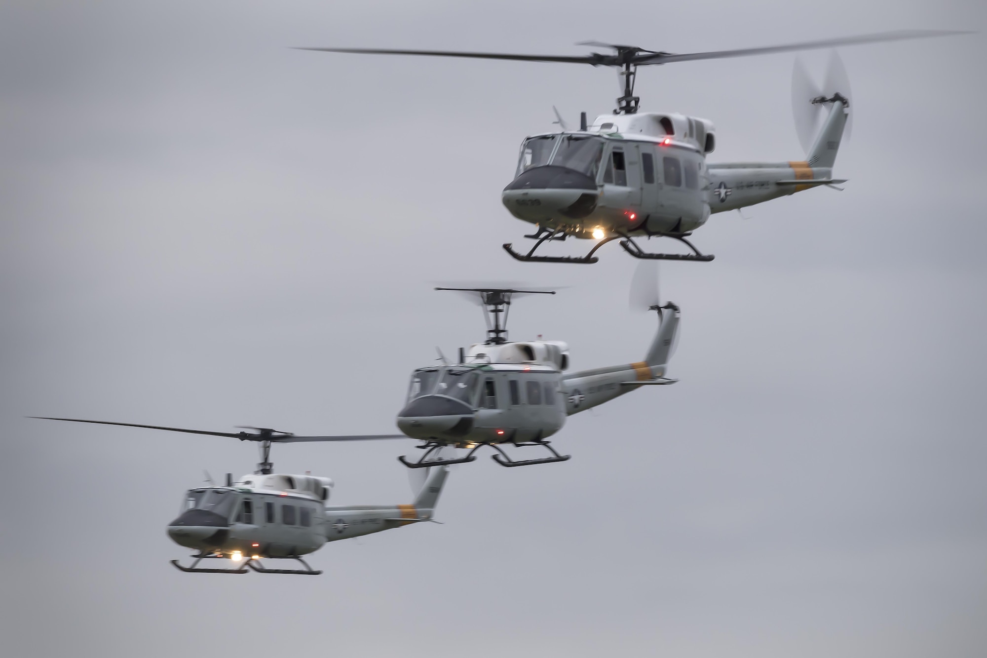Three UH-1N Iroquois helicopters assigned to the 459th Airlift Squadron fly in formation