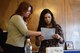 Juli Robertson, AFRC, community readiness specialist and Ruthy Srun, AFRC, community readiness consultant look over the itinerary for Heart Link on Ramstein Air Base, Germany Sept. 28, 2017. Robertson and Srun, have worked for the Airman Family Readiness center for many years and have help to assimilate many military spouses.