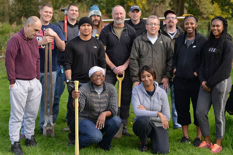 U.S. Air Force Team Mildenhall Airmen pose for a photograph with residents of Middlefield Manor in Barton Mills, England, Oct. 2, 2017.  Middlefield Manor is a care home for individuals who are autistic. Airmen volunteered their time by chopping wood, cutting reeds and building a boat landing dock. (U.S. Air Force photo by Senior Airman Christine Groening)