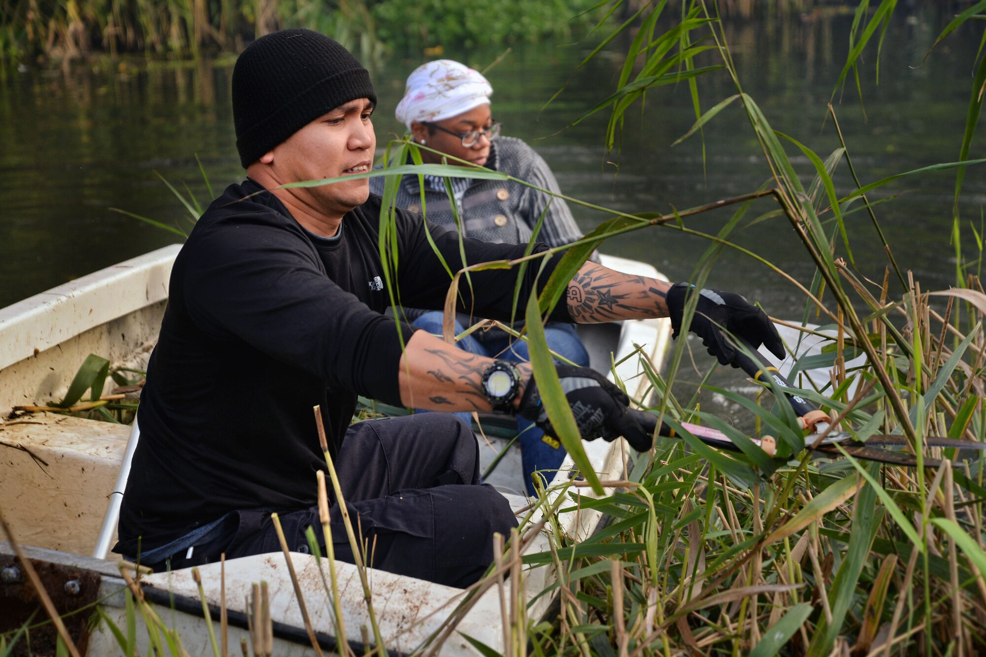 U.S. Air Force Tech. Sgt. Christian Bennet, 352nd Special Operations Wing NCO in charge of personnel programs, cuts reeds in the River Lark Oct. 2, 2017, at Middlefield Manor in Barton Mills, England. Members from the RAF Mildenhall Team 5/6 worked with the residents at Middlefield Manor, providing assistance with any yard work they may need help with. Middlefield Manor is a care home for residents who are autistic. (U.S. Air Force photo by Senior Airman Christine Groening)