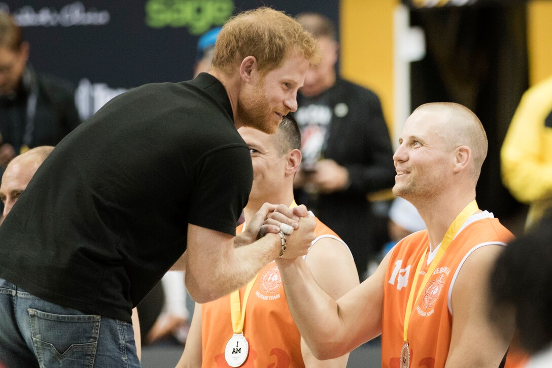 Britain’s Prince Harry awards silver medals to the Netherlands wheelchair basketball team.