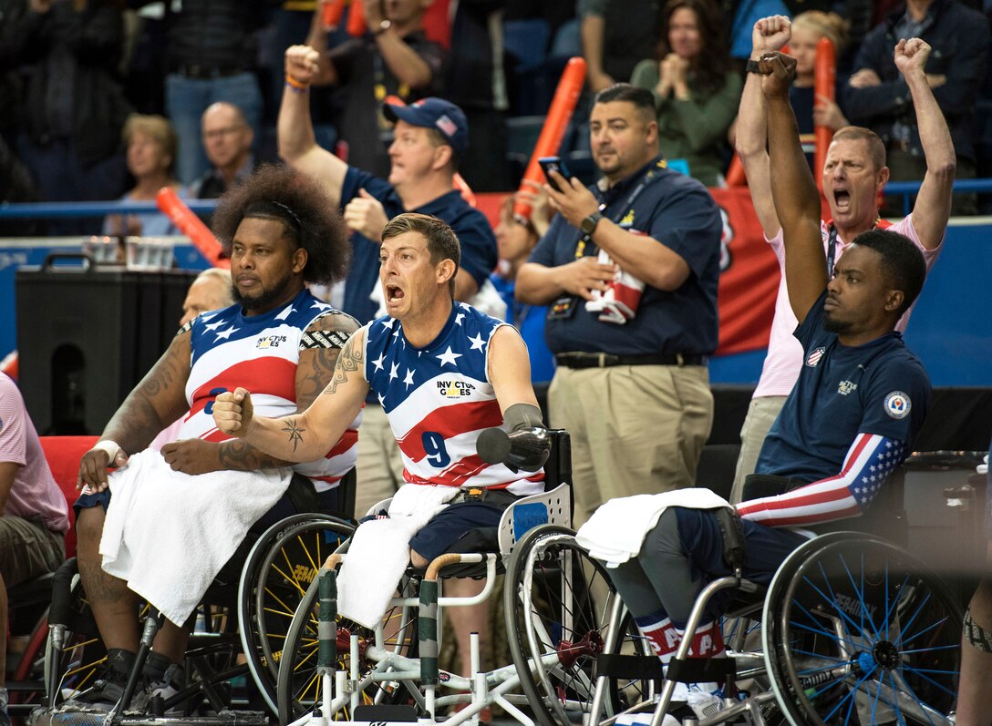 Team U.S. members celebrate after beating the Netherlands team in the gold medal wheelchair basketball game.