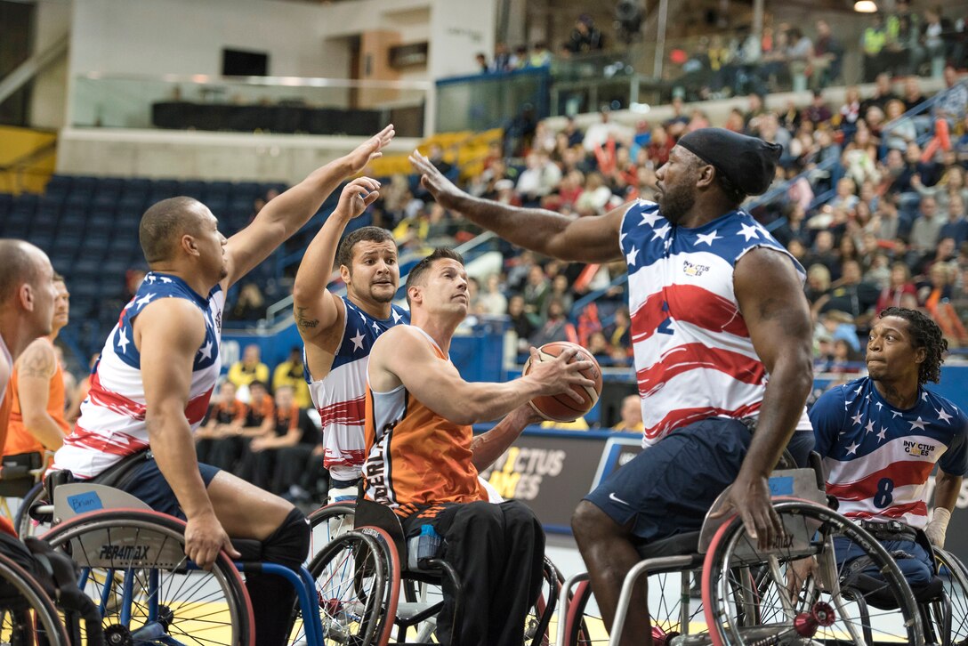 Team U.S. member’s attempt to block Jack Pastora's shot of the Netherlands in the gold medal wheelchair basketball game.