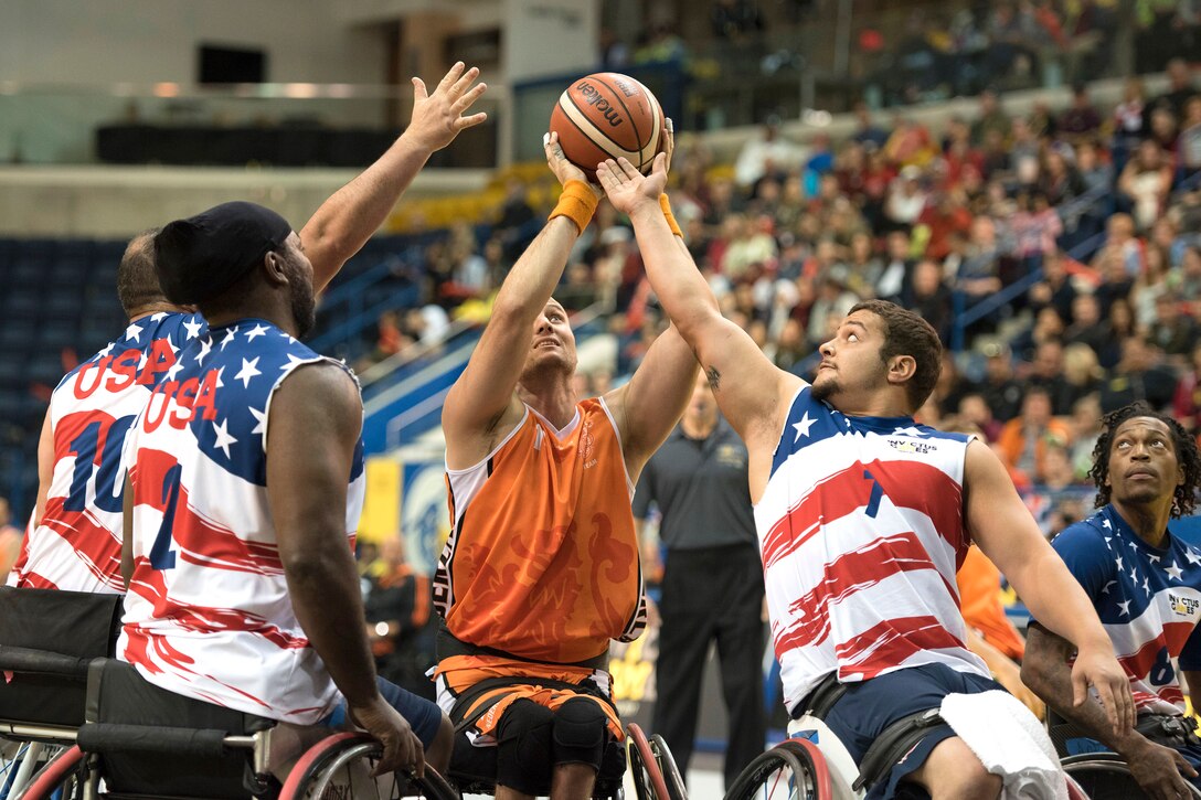 Team U.S. member’s attempt to block a shot by Marc van de Kuilen of Netherlands in the gold medal wheelchair basketball game.