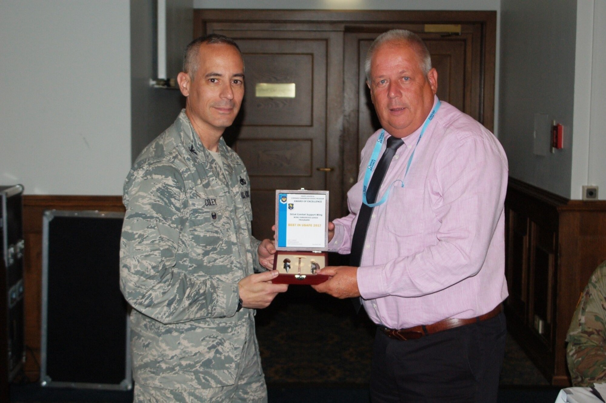 U.S. Air Force Col. Bradford Coley, U.S. Air Forces in Europe and Air Forces Africa chief of the logistics readiness division, presents Mr. Richard Stephen, 501st Combat Support Wing Dangerous Goods Advisor, with the USAFE-AFAFRICA Award of Excellence for his Best in USAFE 2017 Wing Dangerous Goods Program, Sep. 11, 2017. The award recognizes the hard work and dedication of the Wing’s Dangerous Goods program. (U.S. Air Force Courtesy Photo)
