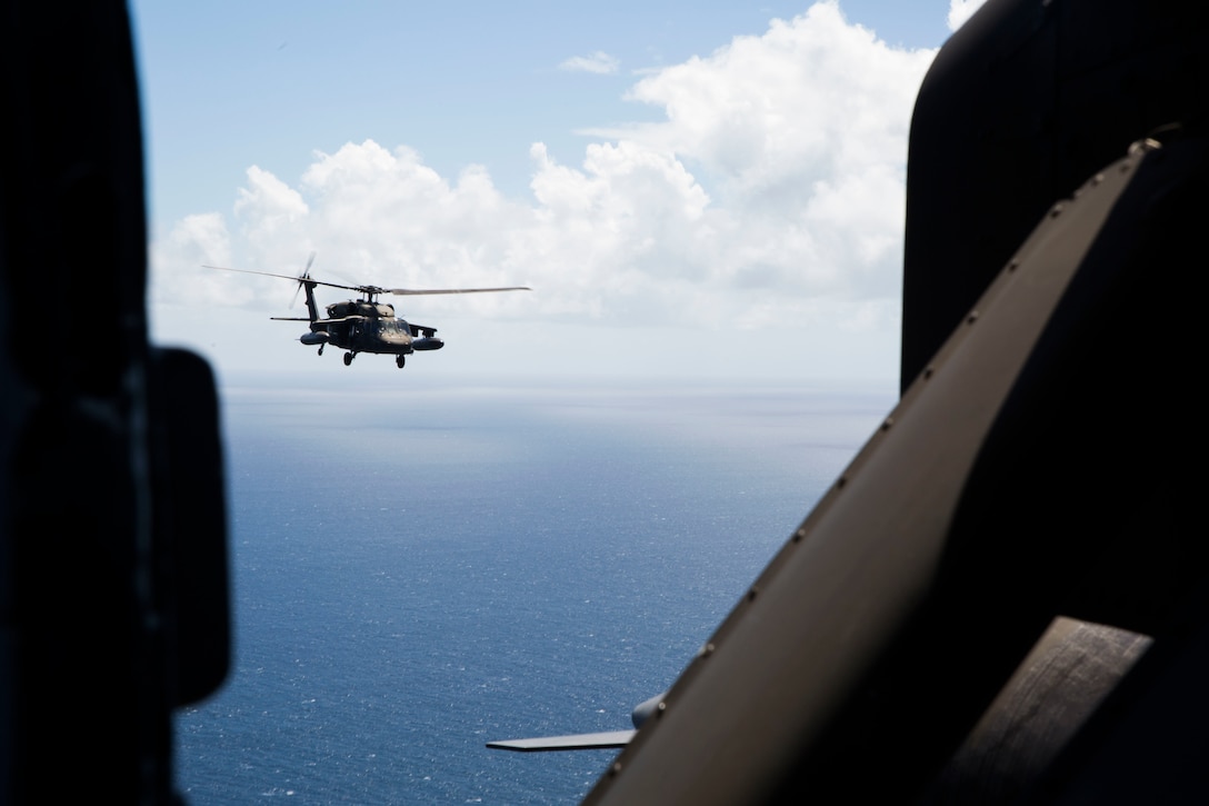 A U.S. Army UH-60 Black Hawk helicopter flies over the Caribbean Sea
