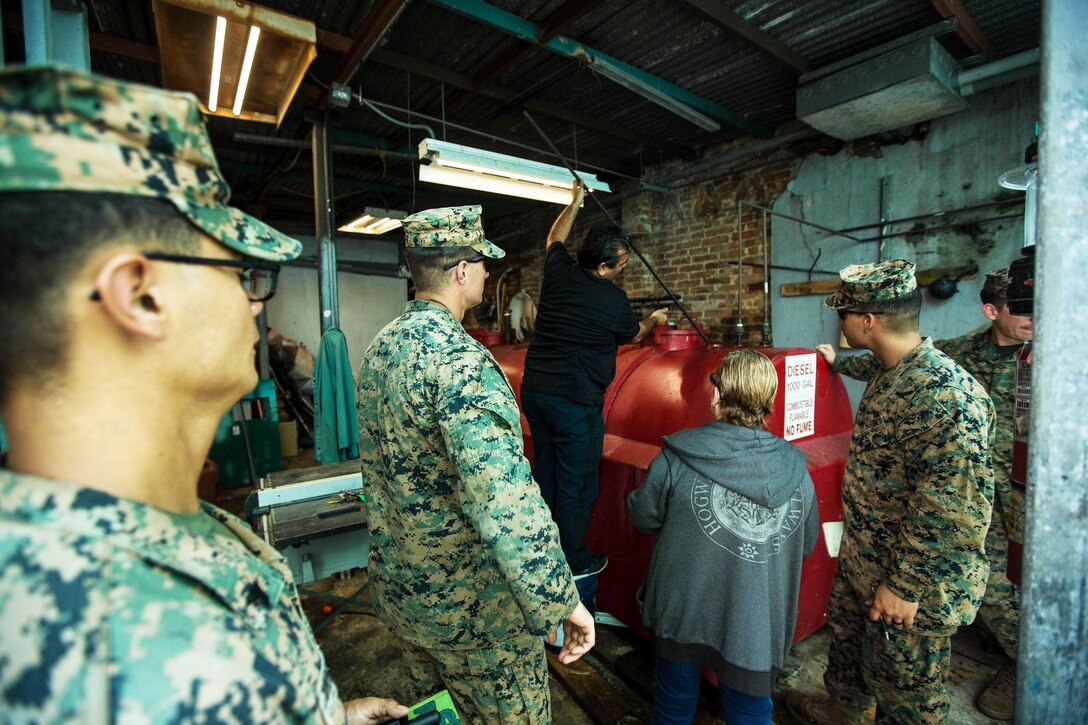 Marines and sailors check out generators for hospital.