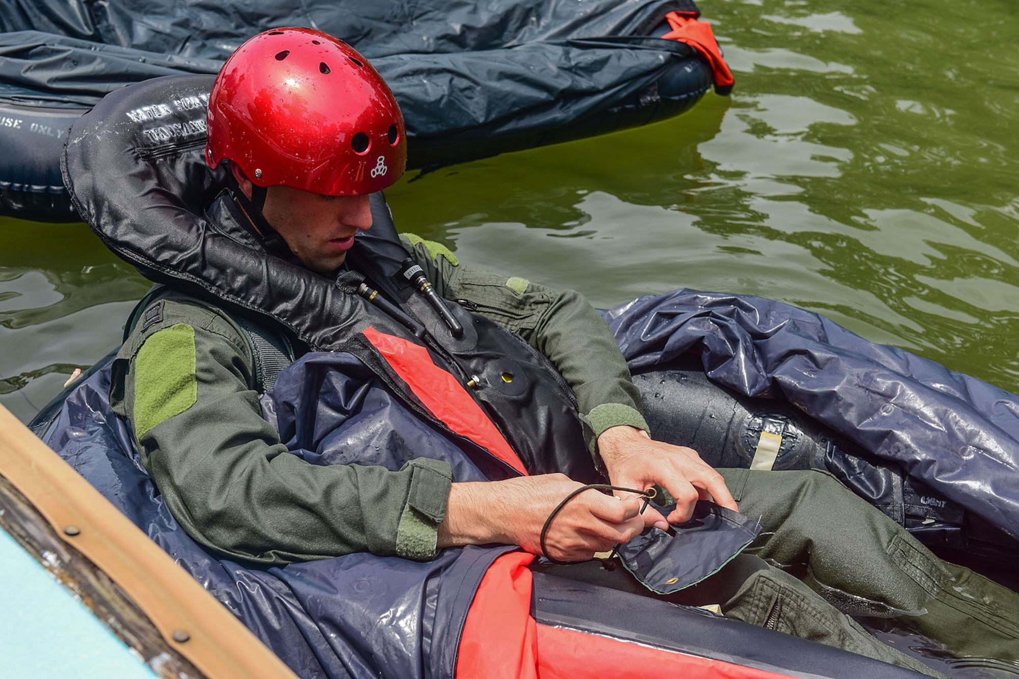 U.S. Air Force Capt. Nathan Price, a pilot assigned to the 157th Fighter Squadron, simulates making repairs to a one man life raft during water refresher training conducted in Lake Murray, located in Chapin, S.C., Aug. 13, 2017. The mandatory tri-annual training assesses the pilot’s ability to combat scenarios that may take place should they have to eject or bailout of the aircraft over water. (U.S. Air National Guard photo by Senior Airman Megan Floyd)