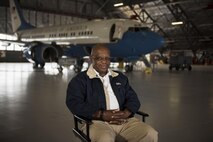 Retired Chief Master Sgt. Robert Brown poses for a photo in front of an executive aircraft on Joint Base Andrews, Md., for the Veterans in Blue project.