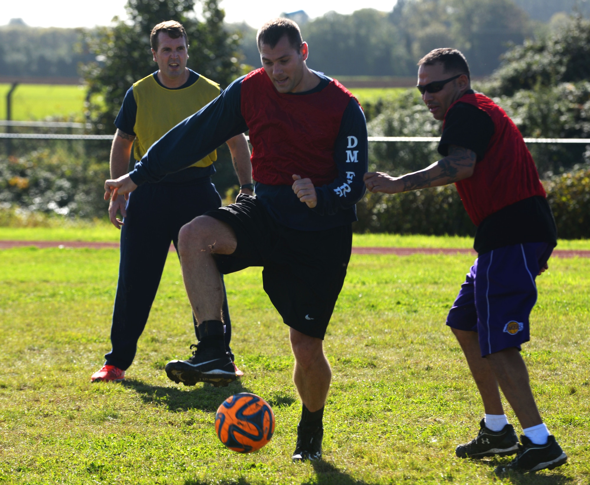 From left, Jamie Greenaway, 100th Civil Engineer Squadron civilian firefighter, U.S. Air Force Staff Sgt. Aaron Scofield and U.S. Air Force Tech Sgt. Andrew Ibarra, 48th Civil Engineer Squadron fire department firefighters play soccer during the Battle of the Badges, Sept. 30,  2017, on RAF Mildenhall, England. The Battle of the Badges was developed as an opportunity for first responders to better develop relationships on and off-base. (U.S. Air Force photo by Airman 1st Class Alexandria Lee)