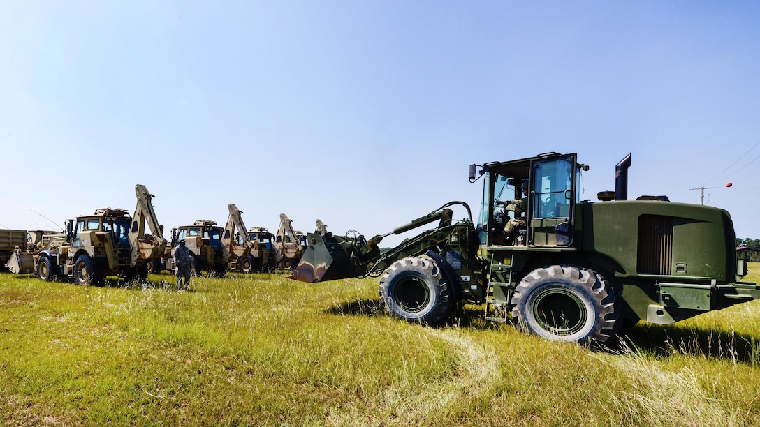 Guardsmen stage heavy equipment to be transported from at McEntire Joint National Guard Base.