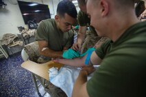 U.S. 5TH FLEET AREA OF OPERATIONS (Sept. 29, 2017) – Marines and Sailors with the 15th Marine Expeditionary Unit and America Amphibious Ready Group practice Combat Life-Saving skills aboard the amphibious assault ship USS America (LHA 6). The Course implemented the use of an IV and the proper protocol when used to save a fellow brother or sister in arms. The 15th Marine Expeditionary Unit is embarked on the America ARG and is deployed to maintain regional security in the U.S. 5th Fleet area of operations. (U.S. Marine Corps photo by Lance Cpl. Dusty Kilcrease)