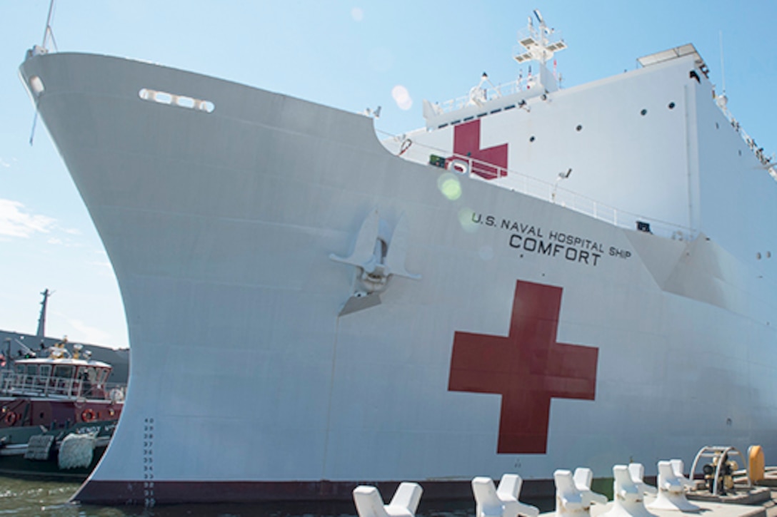 A hospital ship prepares to leave its dock.