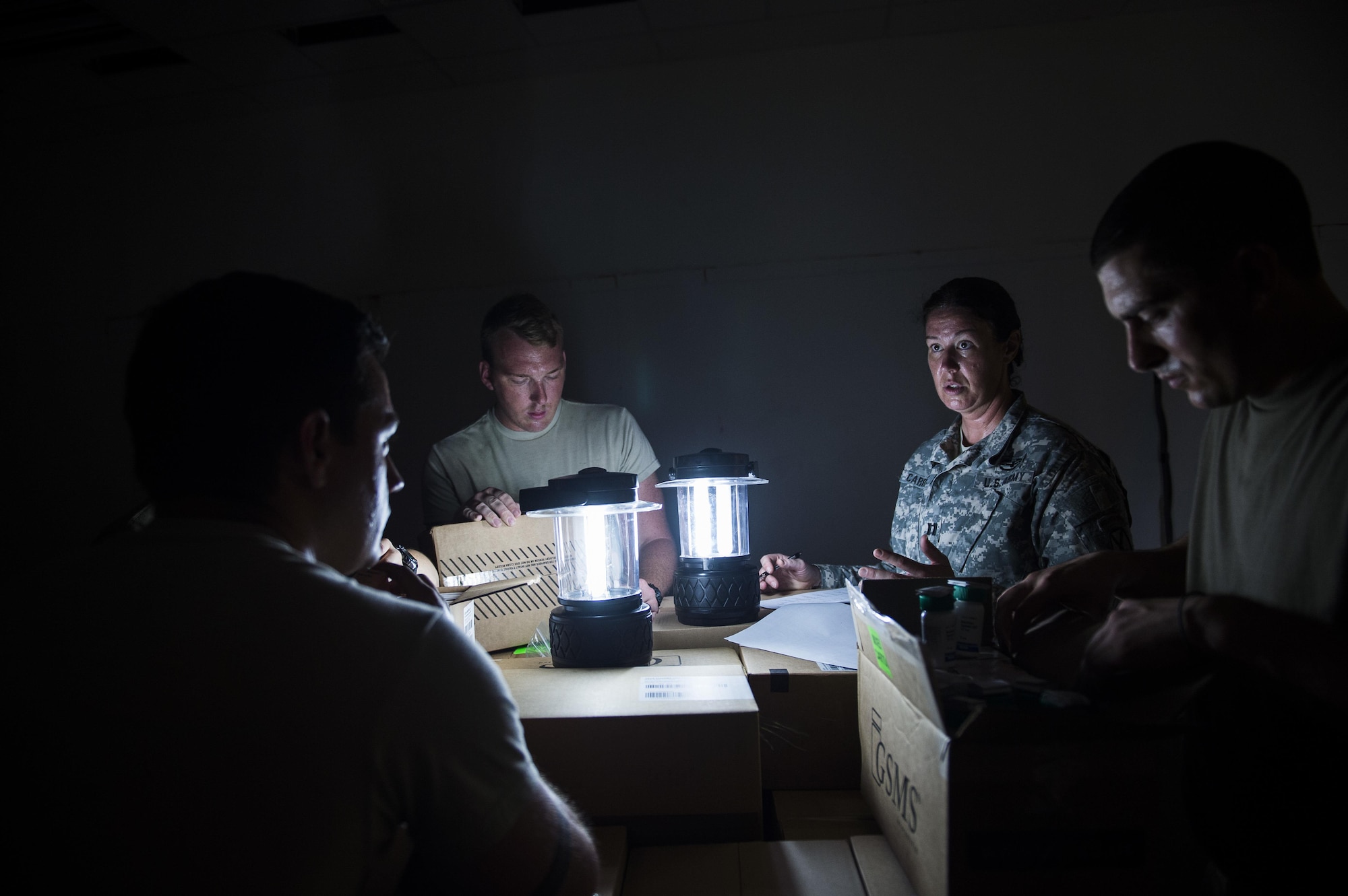 U.S. Army Capt. Beth Carriere, right, a physician assistant assigned to the Vermont National Guard's Medical Detachment, Task Force Bravo, briefs her team on how to organize the donated medications from various organizations at St. Thomas, Virgin Islands, Sept. 28, 2017.