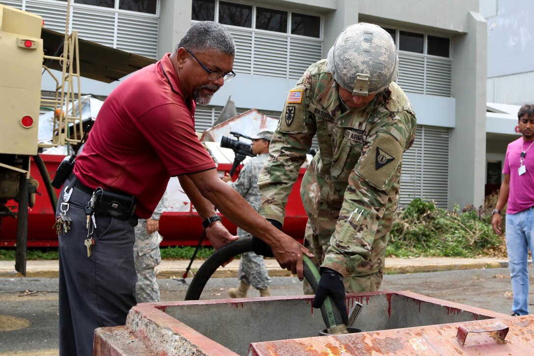 Soldier fills hospital generator with diesel fuel