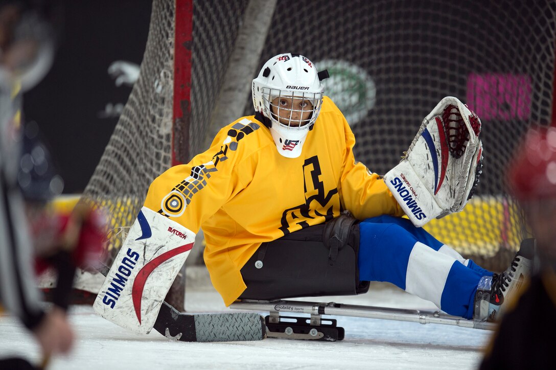 Marine Corps veteran Gabby Graves-Wake makes a save during a sled-hockey exhibition match at the 2017 Invictus Games.