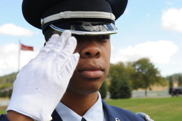 Airman 1st Class Genique Elliott, a heavy equipment operator assigned to the 28th Civil Engineer Squadron, renders a salute during a funeral at Black Hills National Cemetery in Sturgis, S.D., Sept. 26, 2017. While the flag and remains of veterans, retirees and active-duty service members are in motion, the different honor guard members not holding the casket render salutes. (U.S. Air Force photo by Airman Nicolas Z. Erwin)