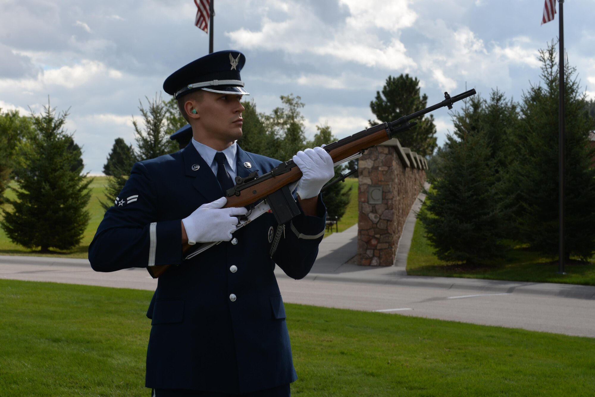 Airman 1st Class Dyllon Schwartz, a crew chief assigned to the 28th Aircraft Maintenance Squadron 37th Aircraft Maintenance Unit, fires a blank round during the nine-volley salute during a funeral at Black Hills National Cemetery in Sturgis, S.D., Sept. 26, 2017. Honor guard personnel undergo a two-week initial training course, followed by returning for training once to twice a week. (U.S. Air Force photo by Airman Nicolas Z. Erwin)