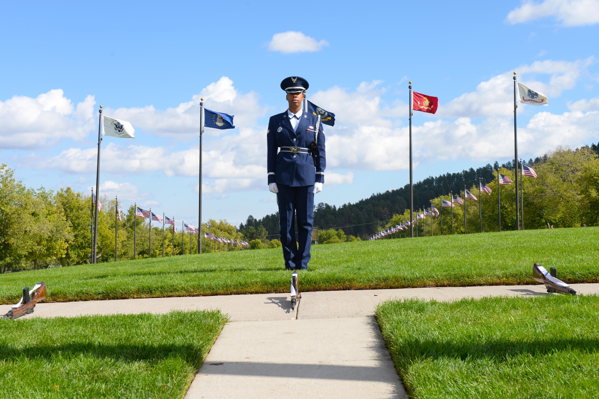 Airman 1st Class Genique Elliott, a heavy equipment operator assigned to the 28th Civil Engineer Squadron, waits for the firing party to arrive to render military honors during a funeral at Black Hills National Cemetery in Sturgis, S.D., Sept. 26, 2017. Each of the funeral detail’s sequences are planned out before the actual ceremony, which include specific positions acting as for different events. (U.S. Air Force photo by Airman Nicolas Z. Erwin)