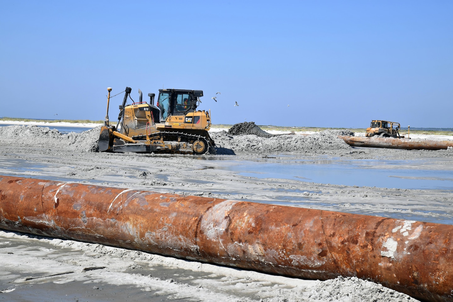 Bulldozers spread sand on Cat Island, Miss., Sept. 29. The island has nearly been restored to its 1990’s shoreline, reducing hurricane risks to Mississippi and boosting the natural habitat for birds and turtles. The shoreline restoration is expected to conclude in mid-October with sand fencing and dune vegetation to be installed by May of 2018.