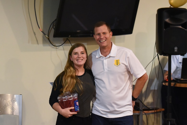 U.S. Air Force Airman 1st Class Breanna Bergeron, 316th Training Squadron trainee, receives the third place prize from Col. Jeffrey Sorrel, 17th Training Wing vice commander, during the Talent Show at the Crossroads on Goodfellow Air Force Base, Texas, Sept. 29, 2017. Bergeron sang a song by Adele titled “All I Ask.” (U.S. Air Force photo by Airman Zachary Chapman/Released)