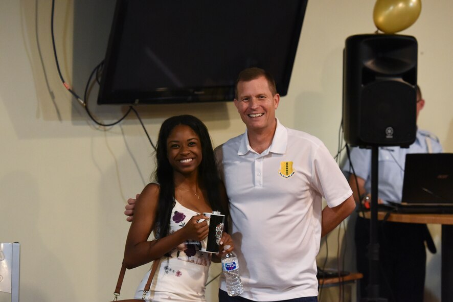 U.S. Air Force Airman Diondra Watson, 315th Training Squadron trainee, receives the second place prize from Col. Jeffrey Sorrell, 17th Training Wing vice commander, during the Talent Show at the Crossroads on Goodfellow Air Force Base, Texas, Sept. 29, 2017. Diondra sang “I Have Nothing” by Whitney Houston. (U.S. Air Force photo by Airman Zachary Chapman/Released)