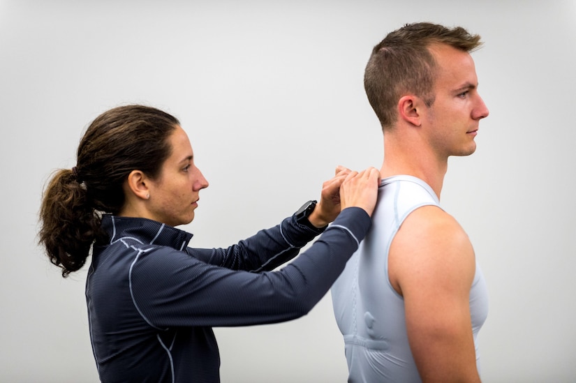 Exercise physiologist Kayla Hierholzer installs a wireless transmitter into base-layer shirt.