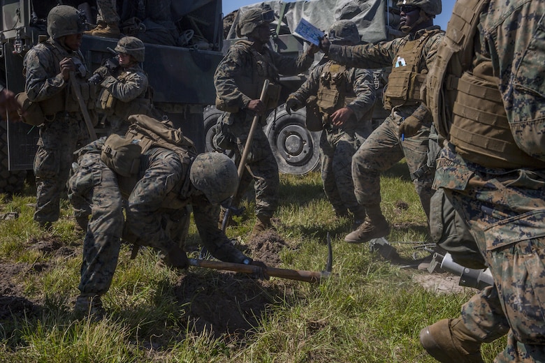 Marines dig holes to emplace an M777 howitzer during a Marine Corps Combat Readiness Evaluation at Camp Lejeune, N.C., Sept. 28, 2017. The Marines conducted the MCCRE to maintain readiness for future operations. The Marines are with 1st Battalion, 10th Marine Regiment. (U.S. Marine Corps photo by Lance Cpl. Taylor W. Cooper)