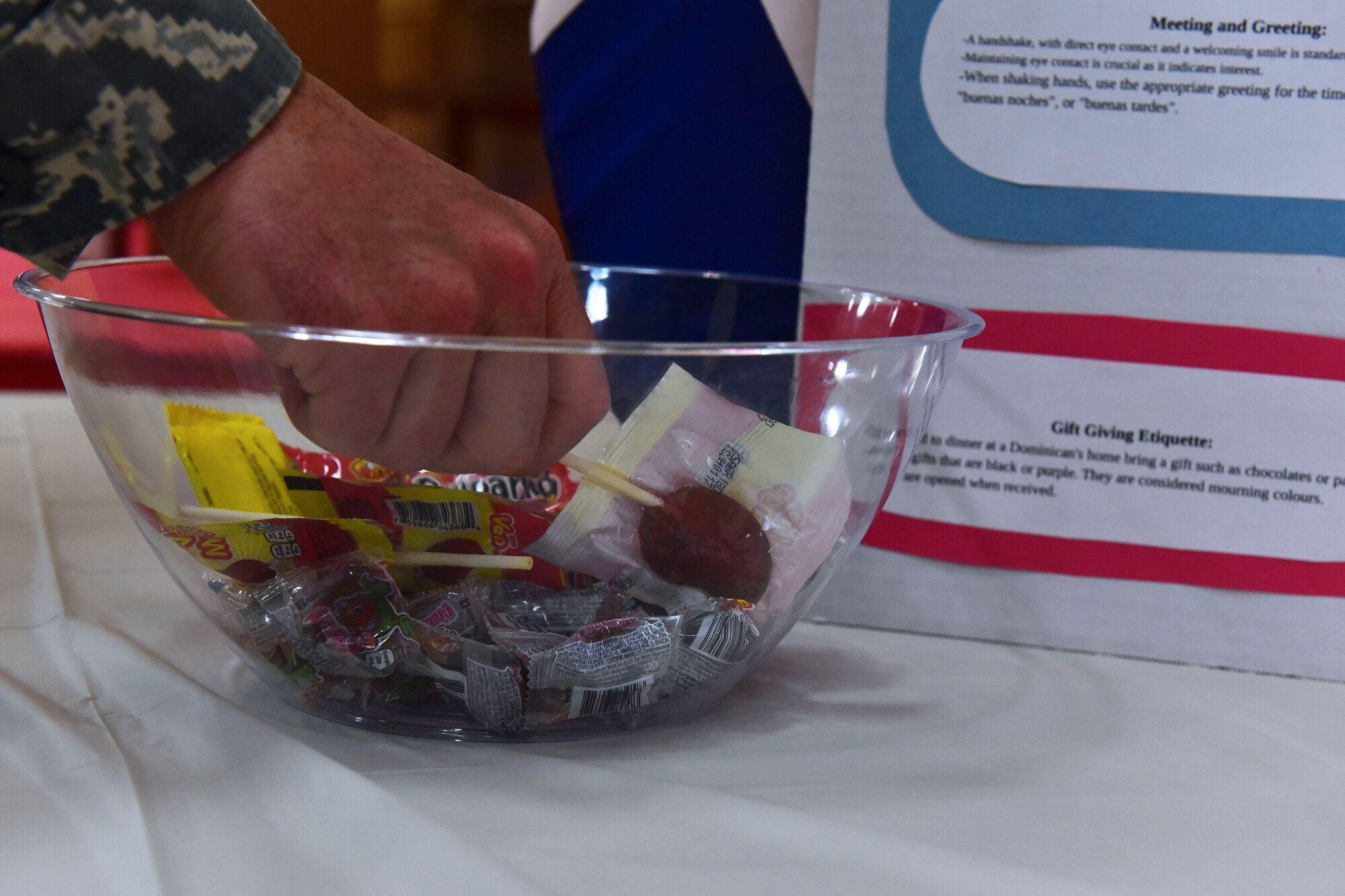 An attendee of the Hispanic Heritage Month Info Fair samples a piece of candy Sept. 29, 2017, at Walter’s Community Support Center on Little Rock Air Force Base, Ark. There were numerous booths featuring various Hispanic countries with candy from each country available. (U.S. Air Force photo by  Airman Rhett Isbell)