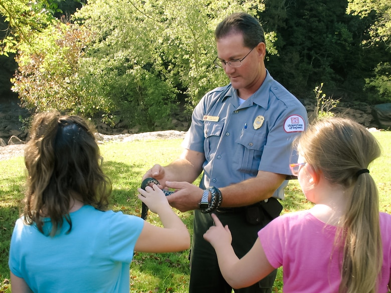 Chris Boggs, Green River Area operations manager, shows a snake to students at Nolin River Lake's EcoMeet.