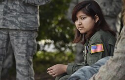 Sandrea Hershey, 14 years old, observes a military working dog demonstration performed by 628th Security Forces Squadron MWD handlers during an Airman for a Day event here, Oct. 2, 2017. The event was hosted by the 628th Air Base Wing and 437th Airlift Wing.  Sandrea was diagnosed with cancer in 2015 and spent approximately 170 days in a hospital. Despite her diagnosis she kept up with her school work and finished her last treatment last month. Sandrea, her mother Lori Hershey and her friend Justin Pippin, met 628th SFS Phoenix Raven members, toured a C-17 Globemaster III with Airmen from the 14th Airlift Squadron and tested their piloting skills in a C-17 flight simulator. (U.S. Air Force photo by Staff Sgt. Christopher Hubenthal)