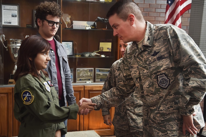 Sandrea Hershey, left, 14 years old, thanks Col. Jeffrey Nelson, right, 628th Air Base Wing commander, for hosting her during an Airman for a Day event here, Oct. 2, 2017. The event was hosted by the 628th ABW and 437th Airlift Wing.  Hershey was diagnosed with cancer in 2015 and spent approximately 170 days in a hospital. Despite her diagnosis Hershey kept up with her school work and finished her final treatment last month. Sandrea, her mother Lori Hershey, and her friend Justin Pippin, also 14 years old, met 628th Security Forces Squadron Phoenix Raven members, observed a military working dog demonstration, toured a C-17 Globemaster III with Airmen from the 14th Airlift Squadron and tested their piloting skills in a C-17 flight simulator. (U.S. Air Force photo by Staff Sgt. Christopher Hubenthal)