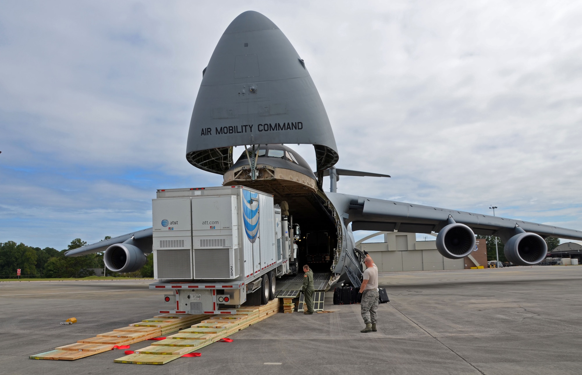 An AT&T communications vehicle is directed onto a C-5M Super Galaxy at Dobbins Air Force Reserve Base, Ga., Oct. 3, 2017. The vehicles were flown to Puerto Rico to assist in the restoration of communications for the island. (U.S. Air Force photo by Tech. Sgt. Kelly Goonan)