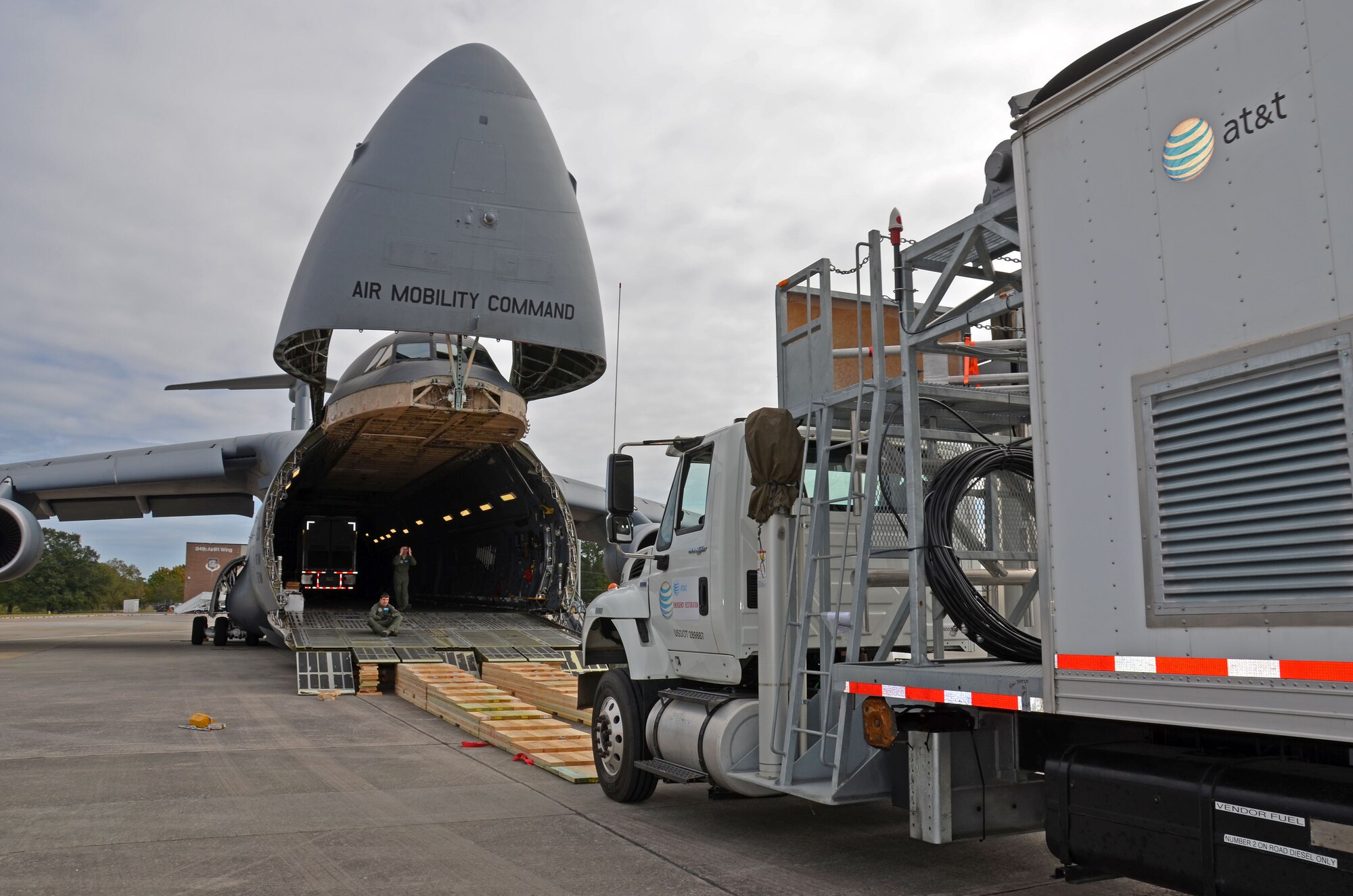 An AT&T communications vehicle is directed onto a C-5M Super Galaxy at Dobbins Air Force Reserve Base, Ga., Oct. 3, 2017. The vehicles were flown to Puerto Rico to assist in the restoration of communications for the island. (U.S. Air Force photo by Tech. Sgt. Kelly Goonan)