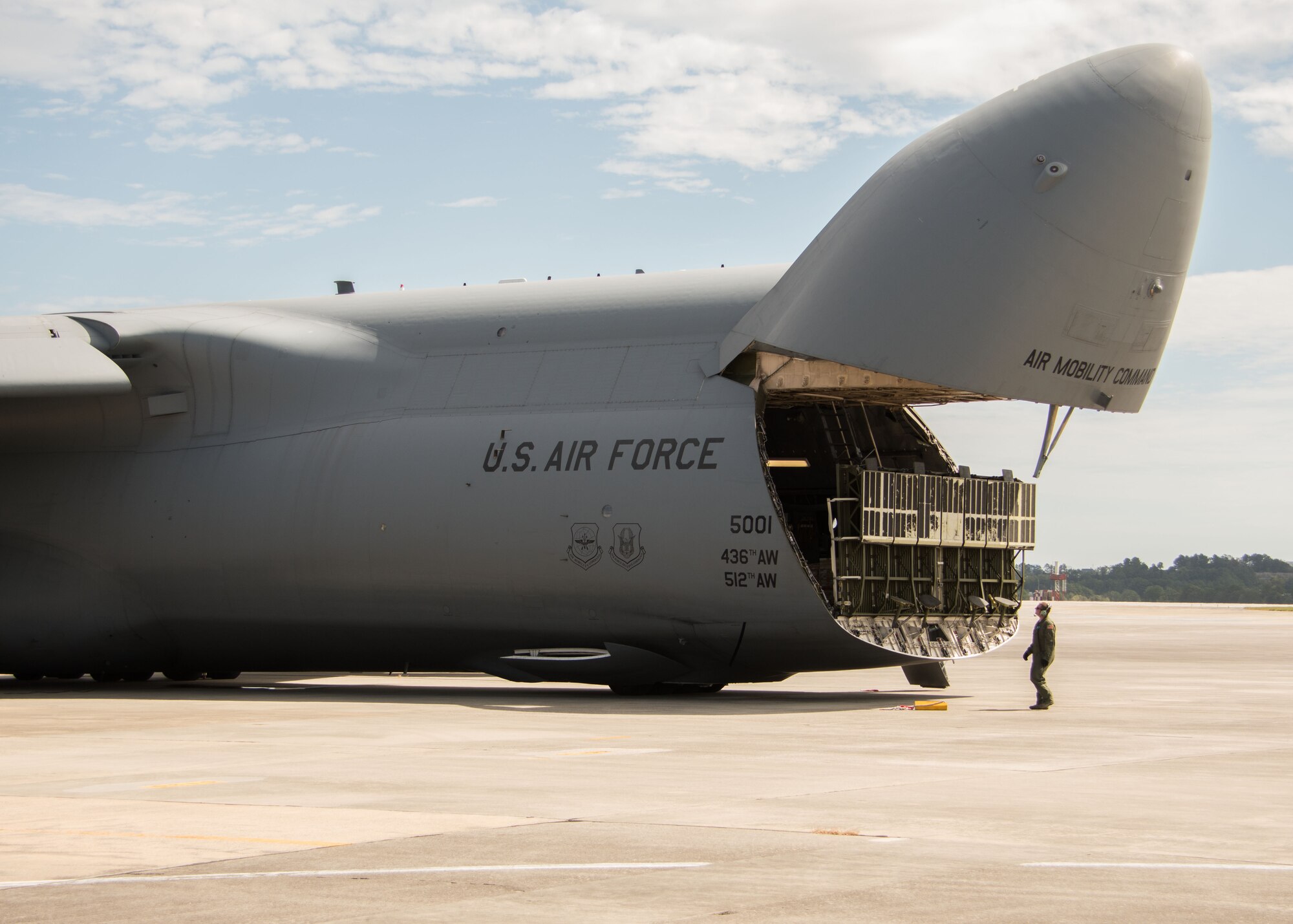 An aircrew member from Dover Air Force Base, Del. watches as a cargo bay door closes on a C-5M Super Galaxy at Dobbins Air Reserve Base, Ga. Oct. 2, 2017. The plane then departed to bring vital communication equipment to Puerto Rico, which was caught in the destructive path of Hurricane Maria. (U.S. Air Force photo/Staff Sgt. Andrew Park)