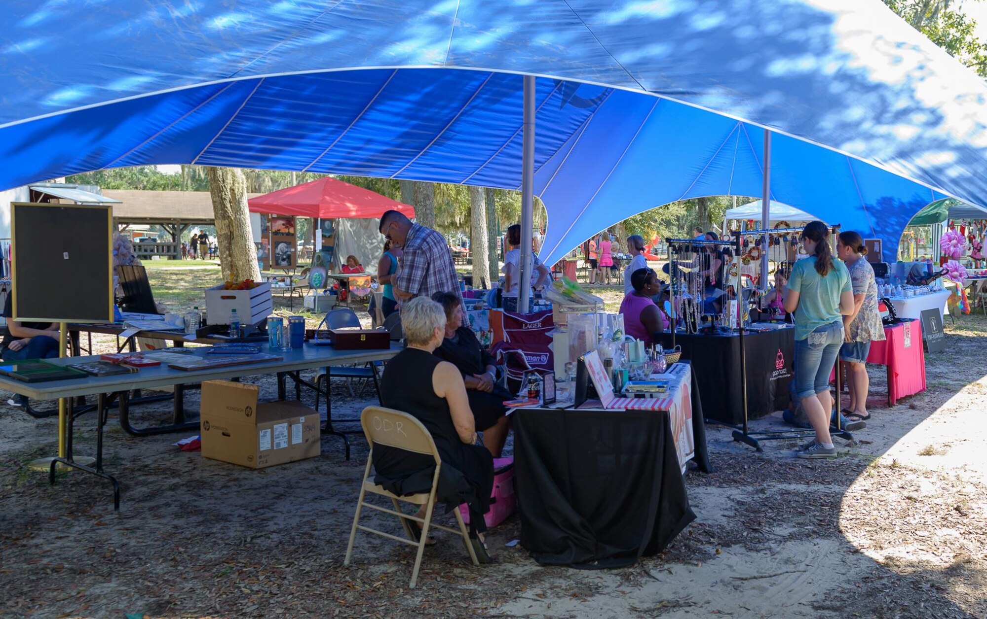 Keesler personnel visit arts and crafts booths at The Marina Park during the 14th Annual Cruisin’ Keesler Car Show Sept 30, 2017, on Keesler Air Force Base, Mississippi. The annual car show is held to kick off Cruisin’ the Coast, a festival to celebrate classic cars, trucks and hot rods, where vehicles cruise down the 30-mile beachside highway in Mississippi. There were over 300 visitors and 130 classic vehicle entries with 15 awards presented. (U.S. Air Force photo by Andre’ Askew)