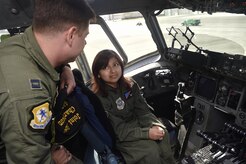 Sandrea Hershey, right, 14 years old, talks to Capt. Keane Carpenter, left, 437th Airlift Wing, during a C-17 Globemaster III tour as part of an Airman for a Day event here, Oct. 2, 2017. The event was hosted by the 628th Air Base Wing and 437th AW.  Hershey was diagnosed with cancer in 2015 and spent approximately 170 days in a hospital. Despite her diagnosis Hershey kept up with her school work and finished her final treatment last month. Sandrea, her mother Lori Hershey, and her friend Justin Pippin, also 14 years old, met 628th Security Forces Squadron Phoenix Raven members, observed a military working dog demonstration and tested their piloting skills in a C-17 flight simulator. (U.S. Air Force photo by Staff Sgt. Christopher Hubenthal)