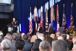 DIA Director Lt. Gen. Robert Ashley, Jr. addresses the crowd with Deputy Secretary of Defense Patrick Shanahan (back left), Director of National Intelligence Daniel Coats (back center) and former DIA Director Vincent Stewart (back right) looking on during the Change of Directorship Ceremony Oct. 3 at DIA Headquarters in Washington, D.C.