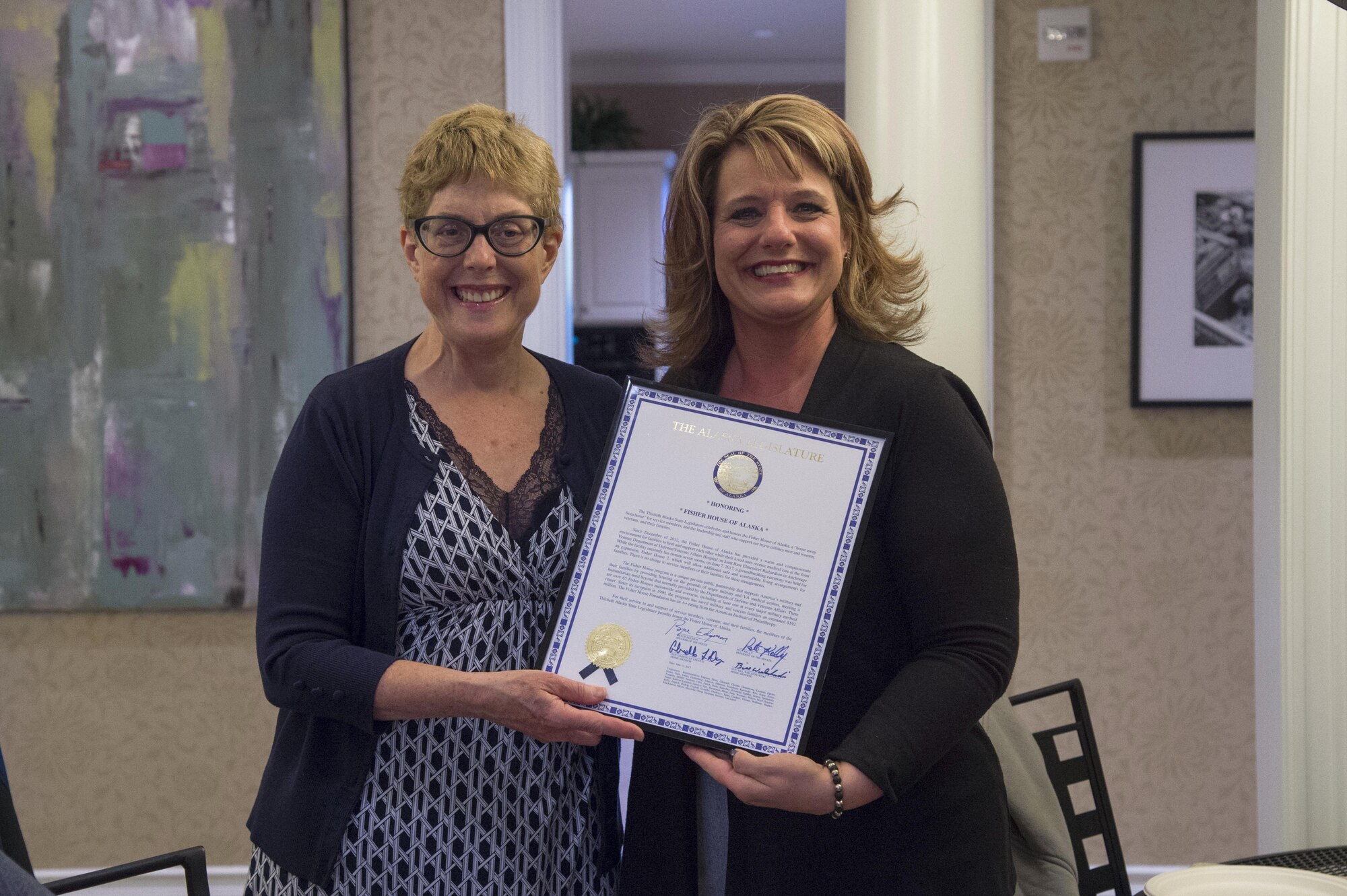 Alaska Sate Representative Gabrielle LeDoux presents Jennifer Hall, Fisher House of Alaska manager, with a legislative citation at Joint Base Elmendorf-Richardson, Alaska, Sept. 28, 2017. The citation was presented to honor and celebrate the Fisher House of Alaska for their support to military members, veterans and family members.